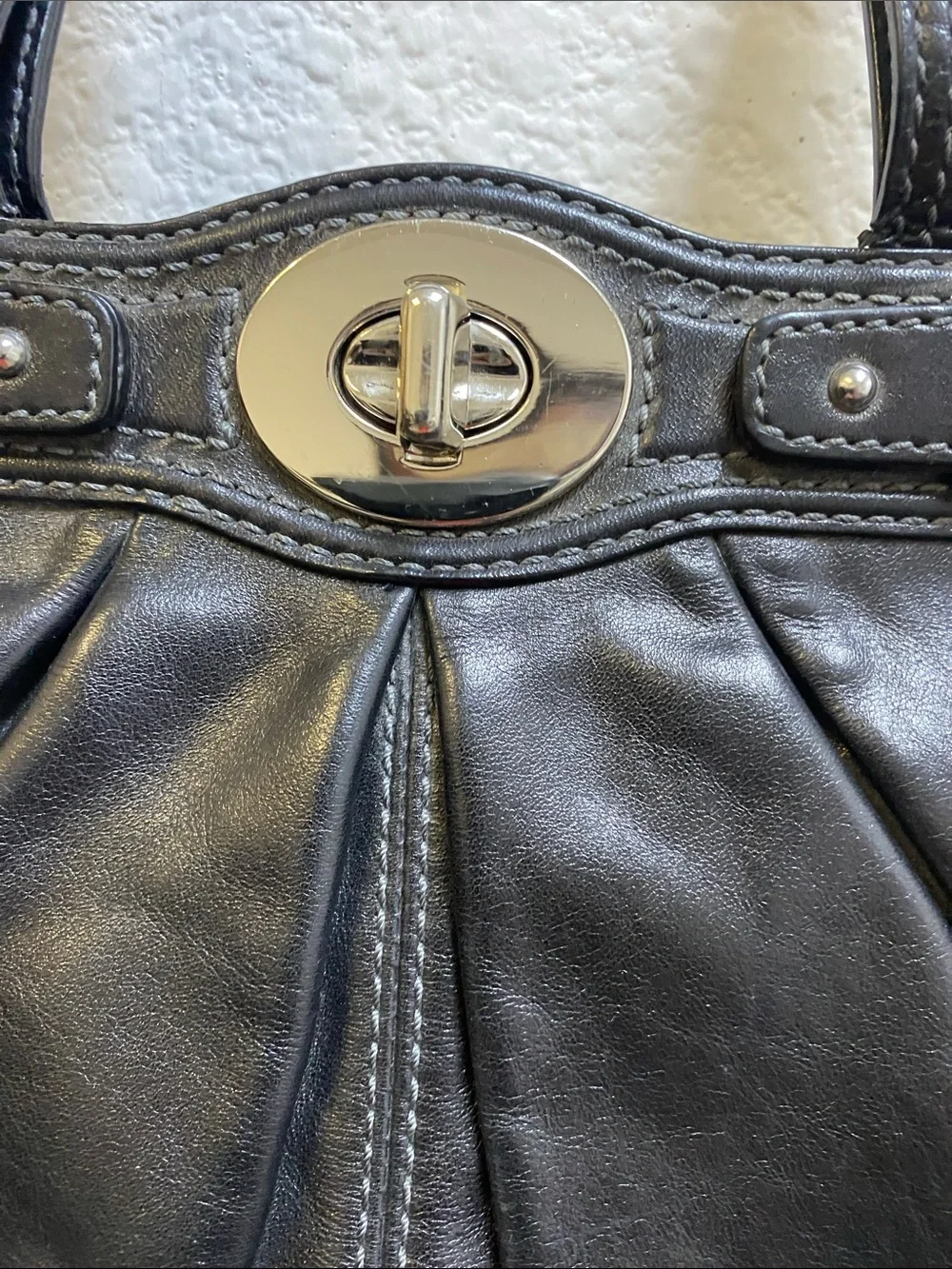 Coach Garnet F13914 pleated shoulder bag with a silver turn lock closure.